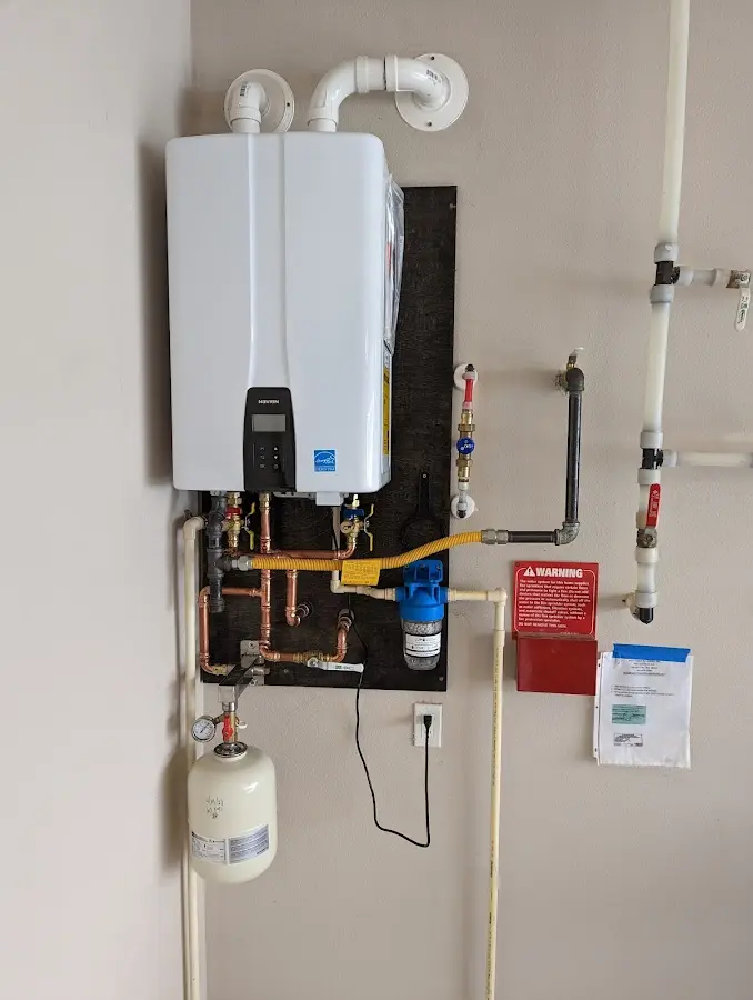 Professional plumber installing copper piping in a Homewood home